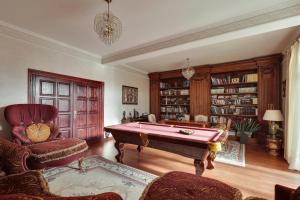 a living room with a pool table and a library at AMARI PARK Residence in Golyama Zhelyazna +47 photos
