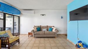 a living room with a couch and two chairs at Beachfront Serene Apt at Victoria del Mar 3F in Stella