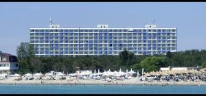 a large hotel with a beach and a large building at Sunset View Blaxy Resort OLIMP by Dany in Olimp