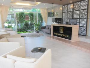 a lobby of a hotel with white furniture at Banyan Residence in Rayong