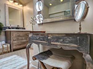 a bathroom with a sink and a vanity with a mirror at Palm Suite in Key West +16 photos