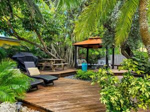a wooden deck with a bench and a gazebo at Palm Suite in Key West