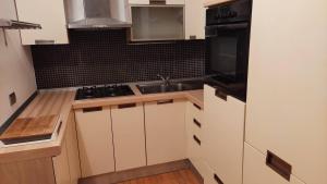 a small kitchen with a sink and a stove at A casa di Sara in Recanati +6 photos