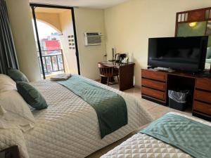 TV a/nebo společenská místnost v ubytování Hotel Bello Cordoba