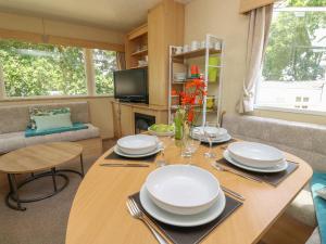 a living room with a table with plates on it at Greenwood in Cowes +18 photos