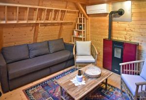 un soggiorno con un divano e un tavolo di Glamping and wellness cottage Salvus a Lendava Altre 10 foto