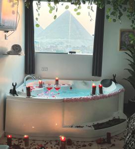 a bath tub with candles and wine glasses in it at Pyramids Paradise icon in Cairo +42 photos