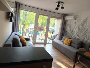 a living room with a couch and a table at Apart & Plus in Okuninka +6 photos