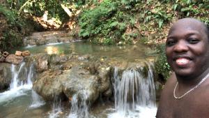 a man standing in front of a waterfall at Camping La Bucara in Cabeza de Vaca +4 photos