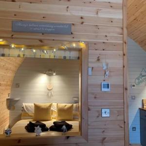 a room with a bed with a mirror in it at Daviot Luxury Pods in Inverness