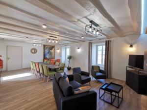 a living room with a couch and a table at Domaine Jolidetour climatisé, piscine et tennis privés in Saint-Crépin-et-Carlucet