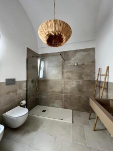 a bathroom with a shower and a toilet and a sink at Donna Vita in Monopoli +45 photos
