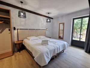 a bedroom with a large bed with white sheets at Domaine Jolidetour climatisé, piscine et tennis privés in Saint-Crépin-et-Carlucet +79 photos