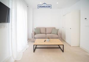 a living room with a couch and a coffee table at Sanlucar Centro - Apartamento 5 in Sanlúcar de Barrameda