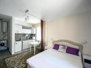 a small bedroom with a bed and a kitchen at Blu Bey Pomorie in Pomorie