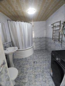 a bathroom with a toilet and a tub and a sink at Saidjanov Hostel in Bukhara +29 photos