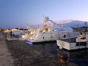 a group of boats docked in a harbor at night at La tenuta Moscatella a 200m dal mare in Schisò +19 photos