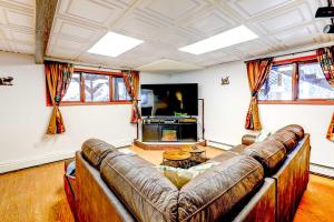 a living room with a couch and a tv at Ideally Located Fairbanks Vacation Rental! in Fairbanks