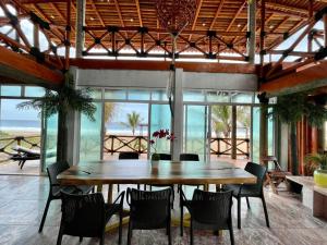 un comedor con una gran mesa y sillas de madera en Villas Coco Mare Suite 4, en Coyuca