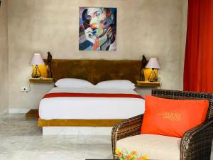 a bedroom with a bed and a couch and two lamps at Villas Coco Mare Suite 5 in Coyuca +37 photos