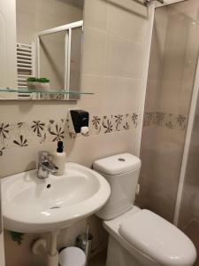 a bathroom with a white toilet and a sink at Dule Lux in Jagodina +8 photos