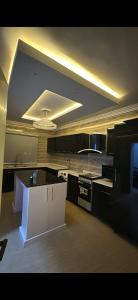 a kitchen with black and white counters and a ceiling at Luxury Two Bedroom Apartment Victoria Island in Lagos