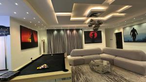 a living room with a couch and a pool table at Luxury Two Bedroom Apartment Victoria Island in Lagos
