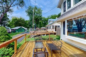 a deck with chairs and a table on a house at Ohana Lake House in Hector