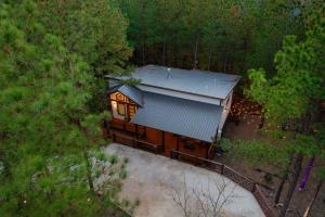 an overhead view of a small house in the woods at Cozy Cabin Perfect for Couples in Broken Bow