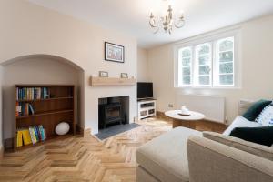 a living room with a couch and a fireplace at Wimborne Hideaway in Bournemouth