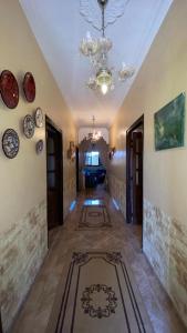 a hallway of a house with a chandelier and a room at Dar Fouzia in Kasba Aït Youdi