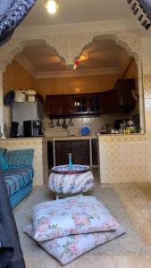 a kitchen with a table and two pillows in a room at Dar Fouzia in Kasba Aït Youdi