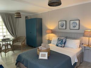 a bedroom with a bed with a blue cabinet at ThePoolhouse Artemida in Áyios Spirídhon