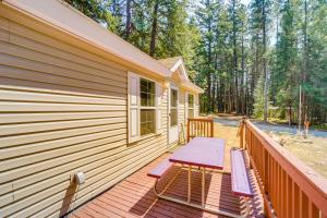 a wooden deck with a picnic table on the side of a house at Peaceful Entiat Home Pets Welcome! in Entiat