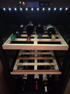 a wine rack filled with wine bottles and glasses at Dule Lux in Jagodina