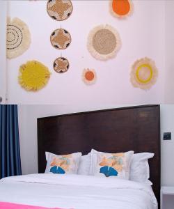 a bedroom with a bed and some decorations on the wall at EDENVILLE HOMES-1 Bedroom Apartment Kiambu Road, Thindigua in Nairobi +14 photos