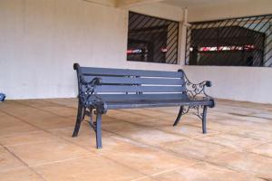 a blue bench sitting on a tiled floor at EDENVILLE HOMES-1 Bedroom Apartment Kiambu Road, Thindigua in Nairobi