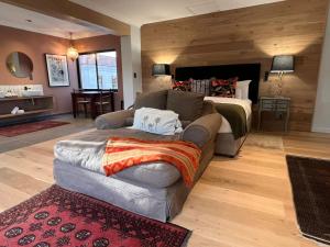 a living room with a couch and a bed at The Whale's Tale Guesthouse in Hermanus