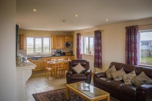 a living room with a couch and a table at Atlantic Sunset in Aughrus More