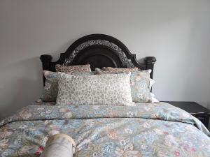 a bedroom with a bed with pillows on it at Benji's Place in The Woodlands +43 photos