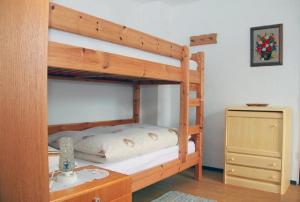 a bedroom with a bunk bed and a dresser at Haus Rita in Thurmansbang