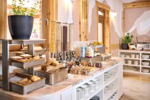 a bakery with bread and pastries on a counter at Hotel Kadoor in Karlovac