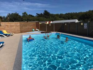 a group of people swimming in a swimming pool at West Camping in Perros-Guirec