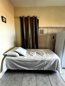 a bedroom with a bed with a bow on it at Pousada Morada Dusanjos in Caraguatatuba +82 photos