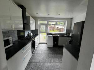 a kitchen with black counter tops and a window at Double Room XX Manchester in Manchester