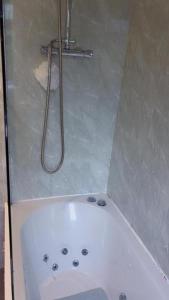 a bathroom with a shower and a white bath tub at Double Room XX Manchester in Manchester