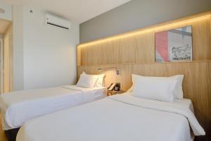 Hampton by Hilton Guarulhos Airport客房内的一张或多张床位