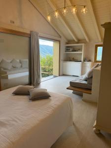 a bedroom with two beds and a large window at Tuvo Houses in Levanto