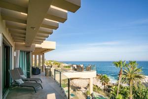 a view of the ocean from the balcony of a house at Villa Alegria in El Pueblito