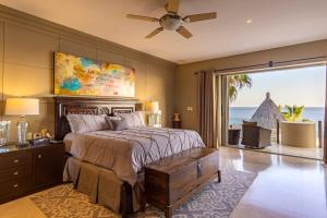 a bedroom with a bed with a view of the ocean at Villa Alegria in El Pueblito